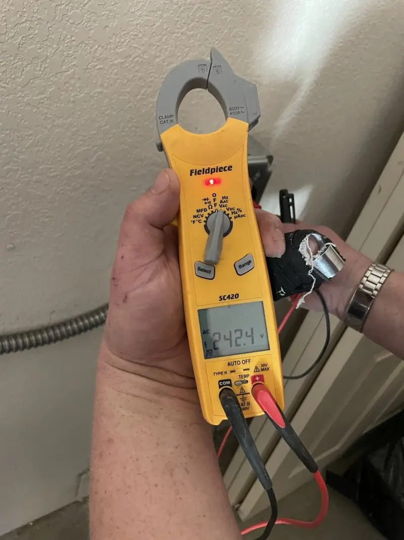 Voltage testing with clamp meter during Outlet Installation in Woodway